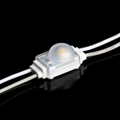 Single led module light with wires on black background