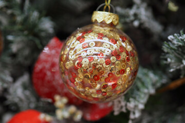 Beautiful Golden Christmas ball on a blurry background of the