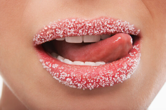 Woman Licking Lips Covered With Sugar