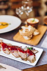rustic wooden table with many plate of delicious and satisfying meals