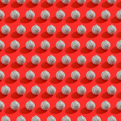 Red shiny Christmas baubles on a pink pastel background. Christmas decorations. Minimal composition seamless pattern background. Christmas and New year concept. Top view, flat lay