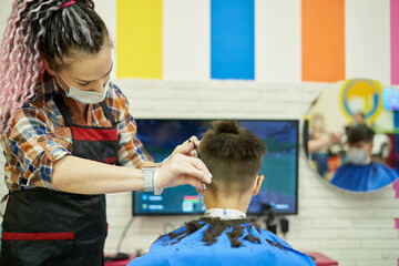 Teenager playing video games at the barber shop