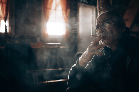 Elderly Man Smoking. Copy Space. Dark Light, Atmospheric, Real Life