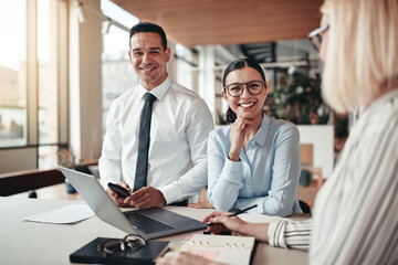 Smiling young businesswoman working with colleagues in an office