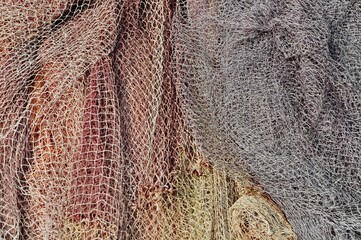 Fishing nets up close. An abstract image of grey, yellow and orange fishing nets. 