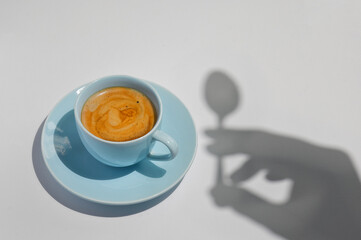 Cup Of Coffee with a Spoon and Hand Silhouette