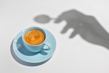 Cup Of Coffee with a Spoon and Hand Silhouette