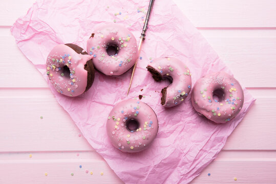 Vegan chocolate donuts with icing and sugar decorations