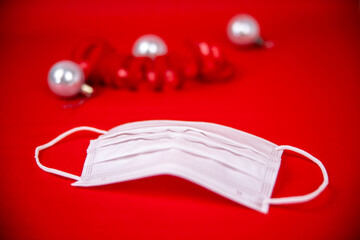 protection mask with christmas decoration on a red background