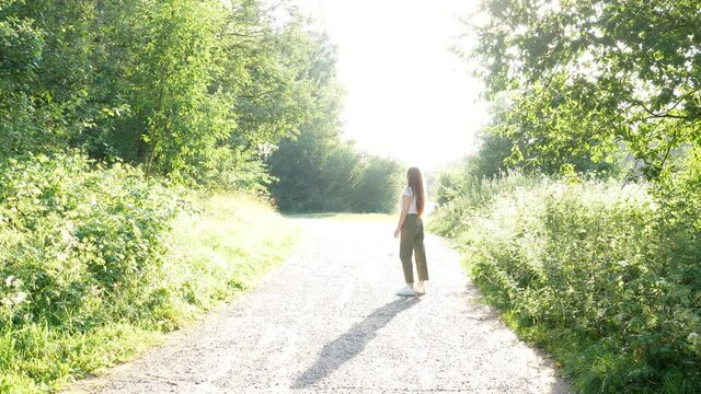 Woman throw stick, dog cath it and run.