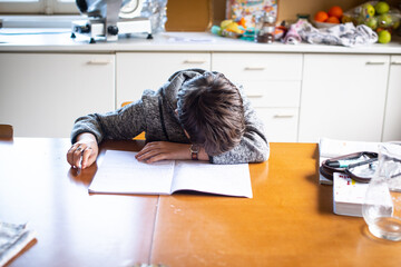 desperate child with head on school book can't do homework
