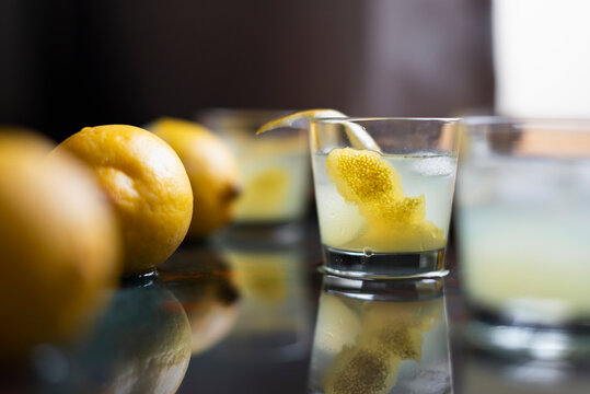 Limoncello with ice cubes and fresh lemon peel