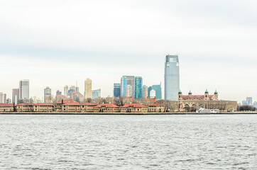 Fototapeta na wymiar Ellis Island Immigrant Station and Jersey City Skyline in Background. New York City, USA