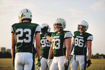 American football quarterback talking with his team during a pra