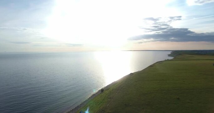 The Baltic Sea From The Steep Hill of Ales Stenar By Sunset in  South Sweden Sk&aring;ne K&aring;seberga, Aerial Forward Slow