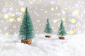 Christmas toy trees on simulated snow. Beautiful festive background for postcards, web, print. Christmas holiday celebration concept