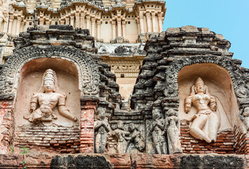 Hampi, Karnataka, India - November 4, 2013: Virupaksha Temple complex. Damaged and molded statues of humans on Shiva Vimanam.