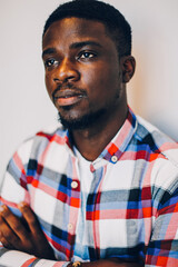 Black guy in shirt posing on white background