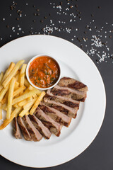 Meat steak and sauce in restaurant