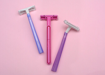 Layout of female disposable razors on a pink background. Close-up