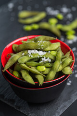 Prepared green beans in a red bowl as starter in restaurant