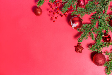 Christmas ornament and fir branches on a red festive background