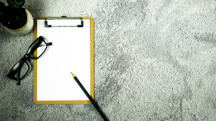 A notebook with pencil and eye glasses on the desk. - Business concept.