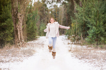 young happy woman outdoor in winter enjoying the snow