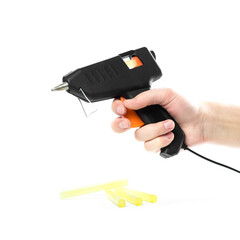 Hand holding a glue gun. Close up. Isolated on a white background