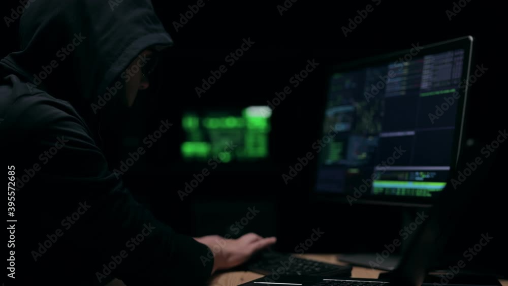 Poster hooded person hacking the secret data code in the server room, state espionage