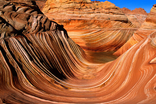 The "Wave" wide shot.  Sand dune layers turned to stone creating surreal world.  Located in the Coyote Buttes area of Vermilion Cliffs National Monument, Arizona, USA