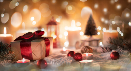 Christmas background with gift and red ribbon, candles, bokeh, toys and snow. Banner