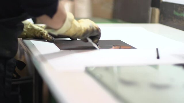 Removing the excess of tint from the brass plate.