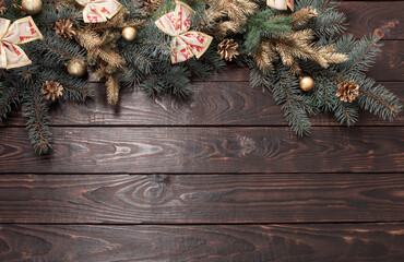 fir branches with Christmas decor on old dark wooden background