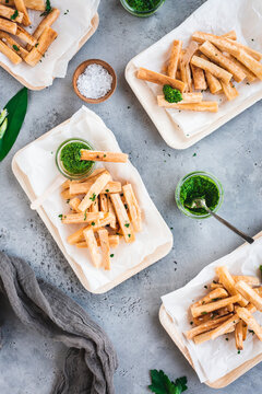 Cassava fries with wild garlic salsa verde in bamboo bowls