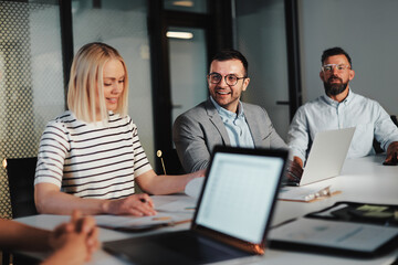 Businesspeople smiling during a meeting
