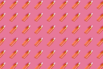 Cosmetic pattern. Yellow anti-aging facial serum in transparent glass bottle with gold pipette on pink background. Hydrating serums, vitamins for skin. Natural organic spa cosmetic beauty concept