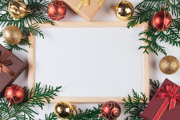 Fototapeta na wymiar Gift boxes and gold festive decor on white background. Mock up for Christmas advertisement.