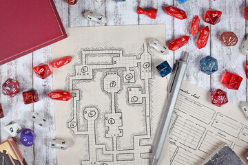 Tabletop role playing flat lay with RPG game dices, hand drawn character sheet, dungeon map and pen...