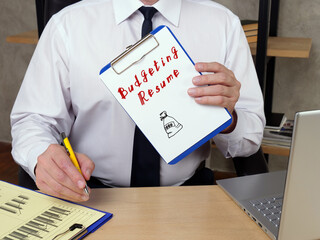 Business concept meaning Budgeting Resume o with phrase on the piece of paper.