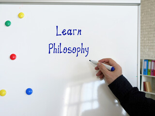 Business concept about Learn Philosophy with sign on the piece of paper.