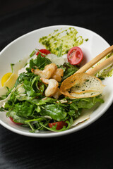 Salad with grilled prawns in restaurant