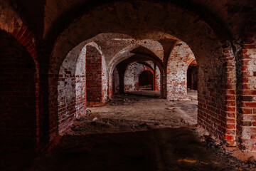 Fototapeta na wymiar Dark and creepy vaulted red brick dungeon
