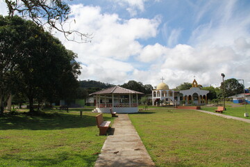 town park with green areas and church