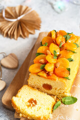 Orange Pound Cake flavored with freshly squeezed orange juice and zest decorated with dried apricots, mint and almonds.