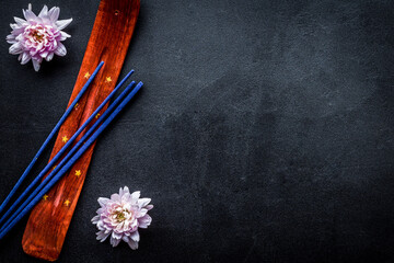 incense sticks with flowers for fresh air on dark background top view mock up