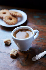 Cup of coffee on rustic wooden background. Close up.