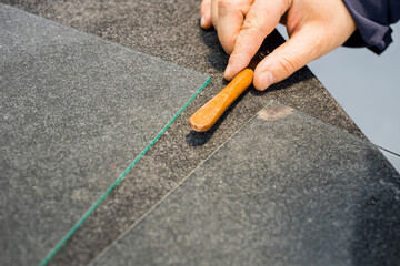 The glazier cuts the glass with a professional tool
