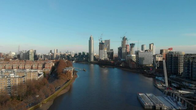 Dolly forward drone shot over Thames river towards The Tower Vauxhall London