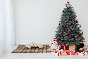 Beautiful holdiay decorated room with Christmas tree with presents under it